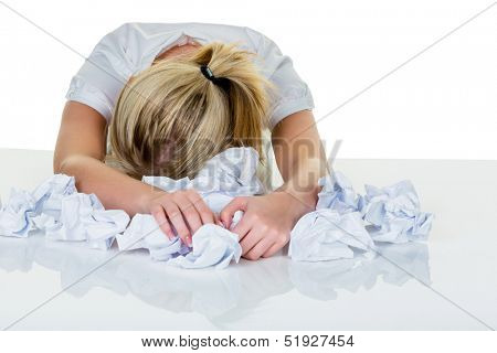 a young woman desperately in office between many file folders and crumpled papier.symbolfoto for stress, burnout and overwork.