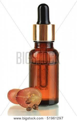 Ripe sliced grape and grapeseed oil, isolated on white