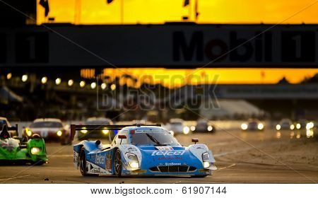 Sebring, FL - Mar 15, 2014:  The Telcel Ford EcoBoost travels through turn one at sunset during the 12 Hours of Sebring at Sebring International Raceway in Sebring, FL.