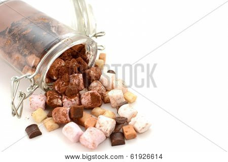 Cocoa And Hot Chocolate Toppings Spill From A Glass Jar