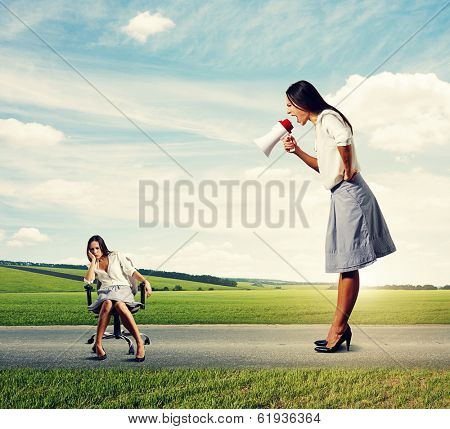 emotional woman screaming at tired woman on the road