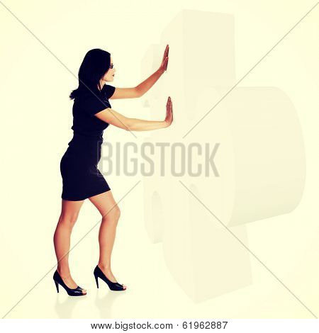 Businesswoman pushing gient puzzle
