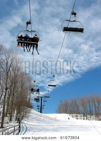 Downhill ski chairlift on a ski resort on bright sunny day