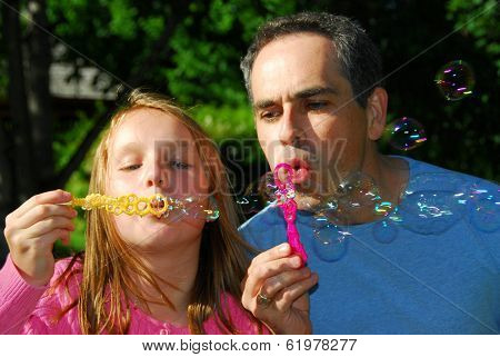 Happy family blowing soap bubbles