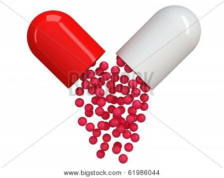 Opened red white pill capsule with crimson granules