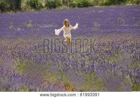 Young girl runs in field of lavender, Provence