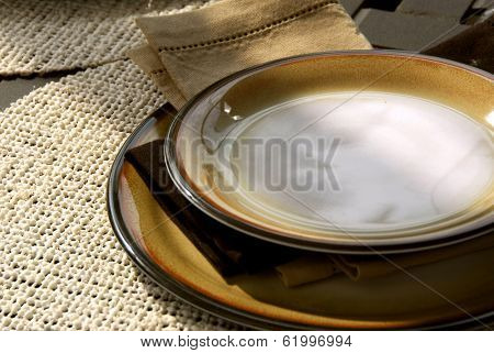 Table setting on a patio table with plates and place mats