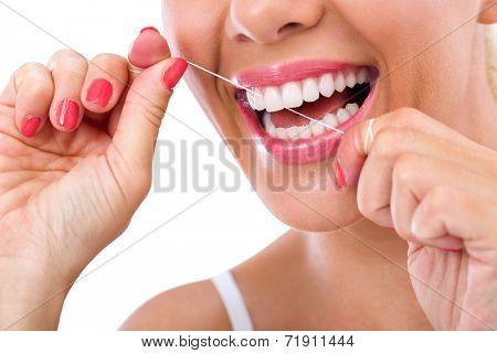Dental flush - woman flossing teeth smiling
