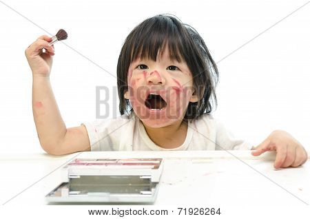 Little asian baby playing with mother's cosmetics