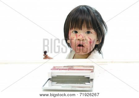 Little asian baby playing with mother's cosmetics