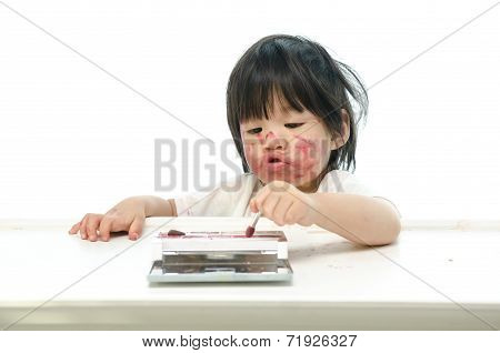 Little asian baby playing with mother's cosmetics