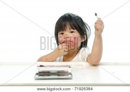 Little asian baby playing with mother's cosmetics