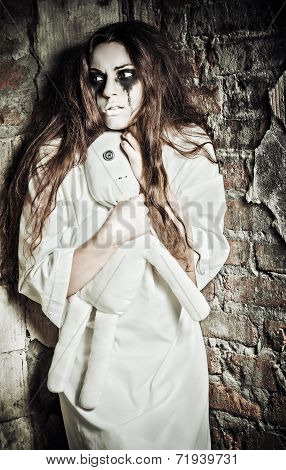 Horror Scene: Strange Crazy Girl With Doll In Hands