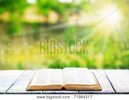 Open book on table outdoors