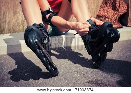Young Woman Putting On Rollerskates
