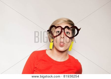 Valentine's Day. Girl with glasses in the shape of heart