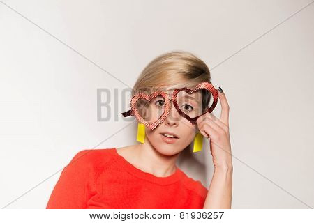 Valentine's Day. Girl with glasses in the shape of heart