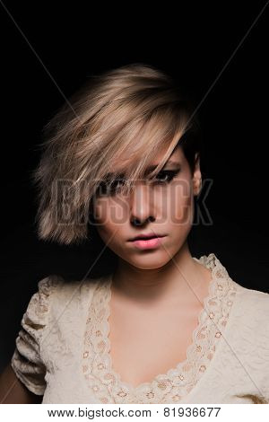 Blonde girl with a short stylish haircut on a dark background