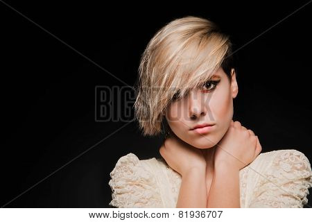 Blonde girl with a short stylish haircut on a dark background