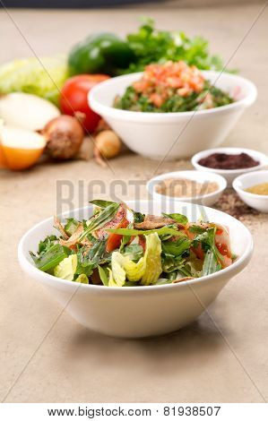 Plates of traditional Arabic salad fattouch and tabbouleh