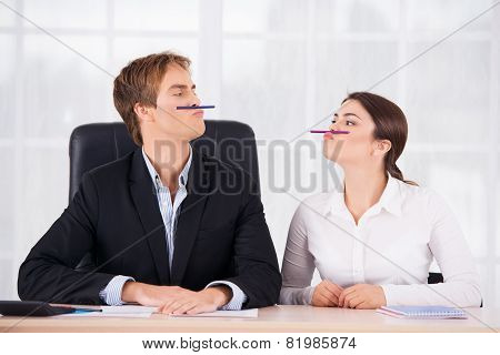 Business woman and man having fun in office