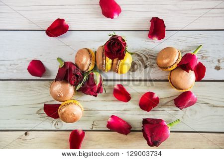 Natural french macaruns and red roses pentals on flat