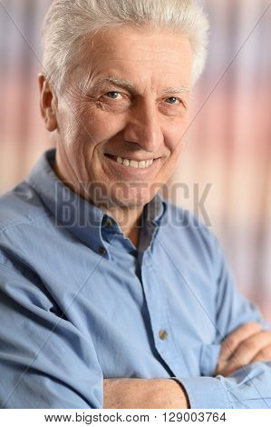 Close-up portrait of cheerful mature man at home