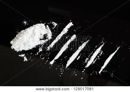 Lines of cocaine on the black background