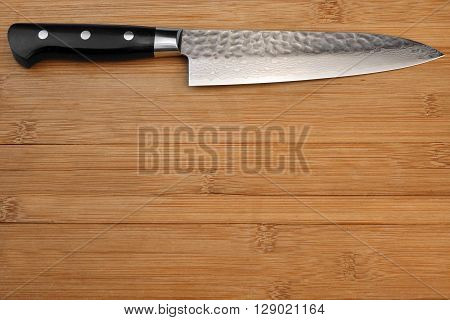 Japanese Professional Kitchen Knife On The Bamboo Cutting Board