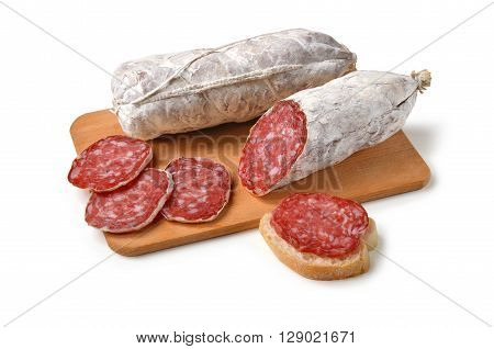 Two pieces of Salami and slices on Cutting board