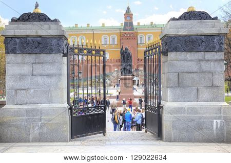 MOSCOW RUSSIA - April 24.2016: Tourists and citizens walking on the territory of the Alexander Garden near the monument to Patriarch Hermogenes near the Kremlin