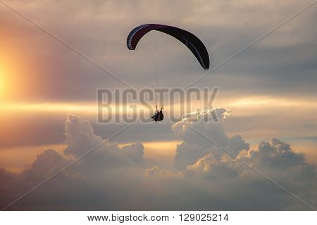 Boy And Girl Flying On A Paraglider On A Background Of Clouds