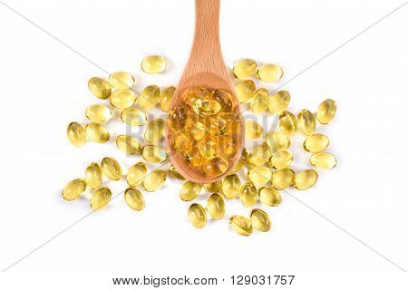 Fish Oil Capsules In A Wood Spoon On White Background