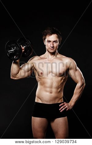 Handsome Athletic Man With Dumbbells Confidently Looking Forward. Strong Bodybuilder With Six Pack,