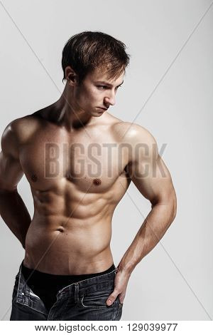 Handsome Athletic Man Looking At Side In Unbuttoned Jeans. Strong Bodybuilder With Six Pack, Perfect