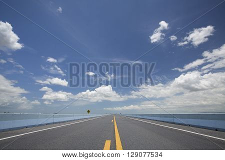Straight and empty road with blue sky
