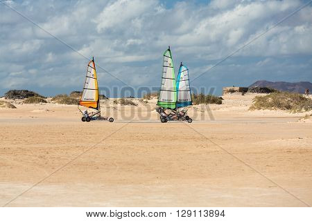 Corralejo Fuerteventura Spain - Spetember 15 2015: People Driving Sand Yachting On The Beach. They A