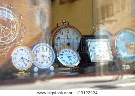 TIMISOARA, ROMANIA - JULY 29, 2015: old russian alarm clocks SLAVA and ANKER made in West Germany in a showcase of Timisoara downtown
