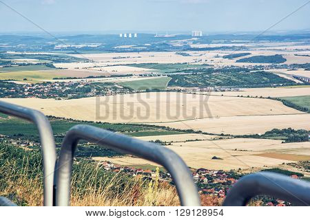 Rural landscape from the hill Zobor near the Nitra city Slovak republic. Mochovce nuclear power plant in the distance. Meadows and fields.