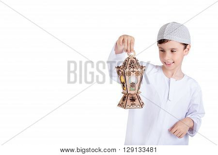 Ramadan Kareem - Ramadan Greeting Card - Happy young kid playing with Ramadan lantern