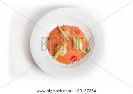 Cold gaspacho soup with scallop on white background
