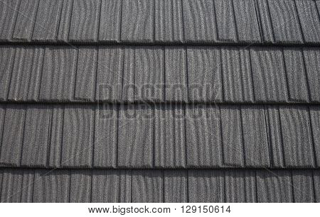 Roof with black bitumen shingles pattern abstract
