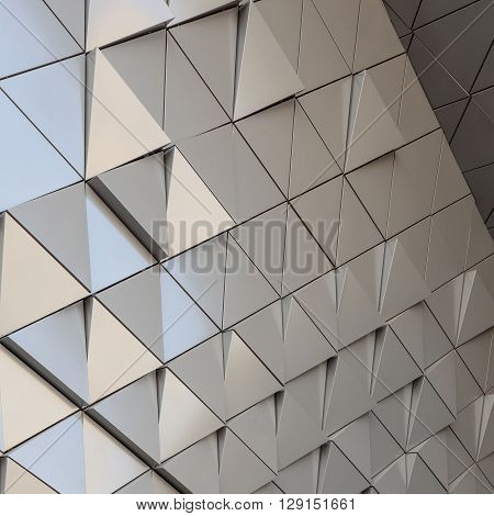 Abstract close-up view of modern aluminum ventilated facade of triangles