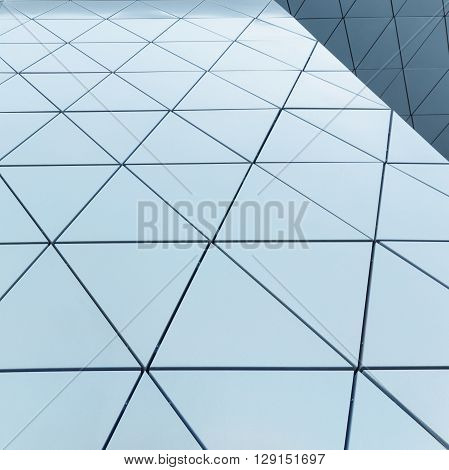 Abstract close-up view of modern aluminum ventilated facade of triangles