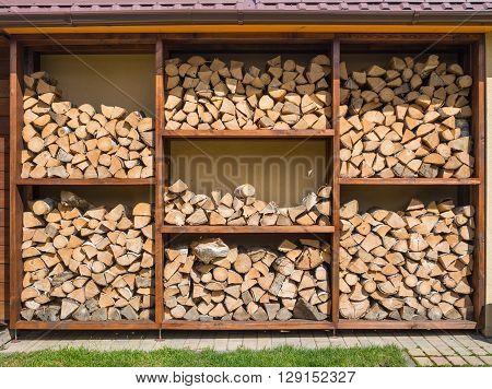 Stack of firewood ready for the fireplace divided in square boxes