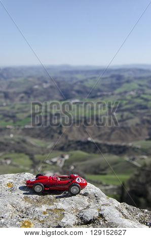 Scale model of famous red car with a panoramic background