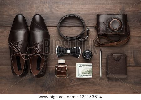 men's accessories in oder on the brown wooden table overhead view