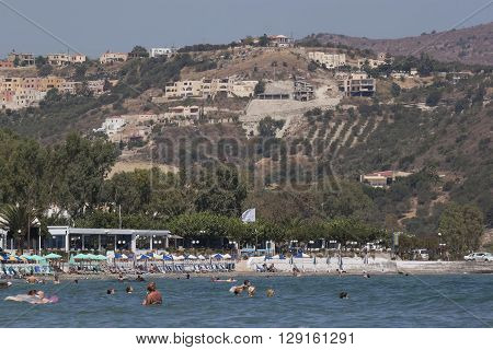 GEORGIOUPOLIS GREECE - JULY 30 2013: Beach of Georgioupolis view from the sea. Georgioupolis - a former fishing village now a popular holiday destination of tourists from all over Europe