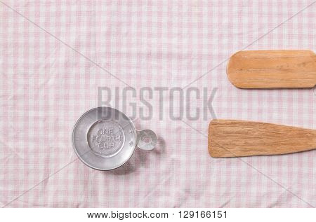 Small paddle and tray for cooking sweet tablecloth background