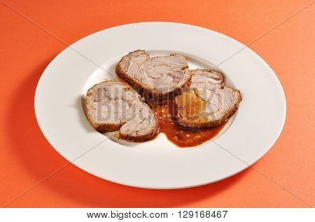 Plate with a portion of three slices of roasted veal portion